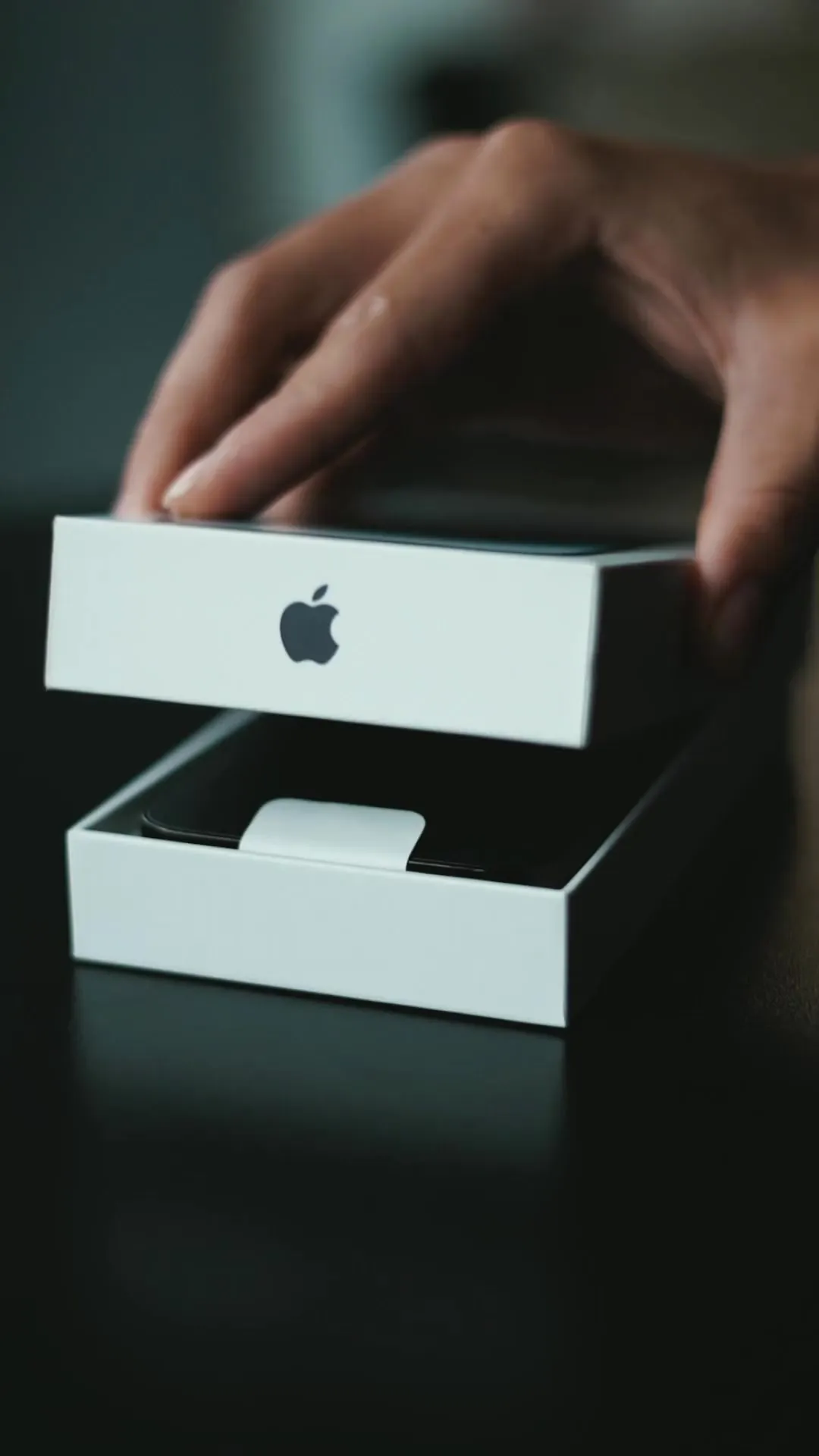 A new phone in its box, the lid lifting away